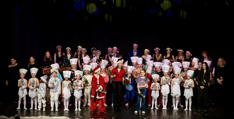 Ensemble der Musicalschule Ahrensburg auf der Bühne in Nikolaus- und Weihnachtskostümen zur Adventsshow.