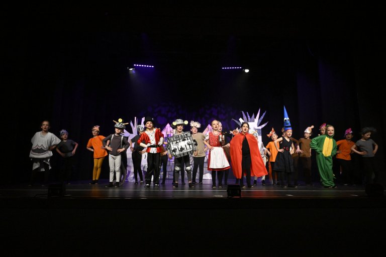 Kinderensemble der Musicalschule Ahrensburg in bunten Kostümen auf Bühne bei MSA10 Jubiläumsshow.